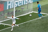 Portugal's Cristiano Ronaldo holds arms wide while goalkeeper pulls goal out of net
