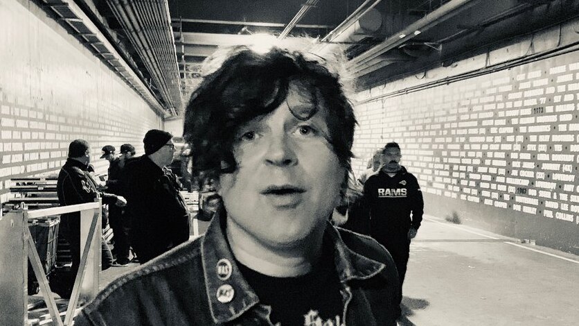 A black and white photo of Ryan Adams backstage