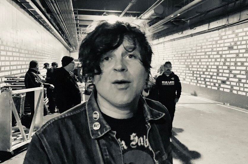A black and white photo of Ryan Adams backstage