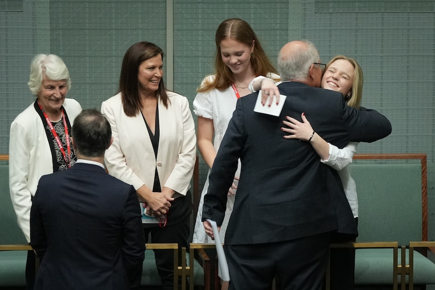 Morrison hugs his daughter in the gallery of the House of Representatives.