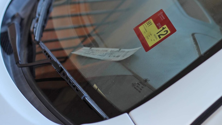 Car windscreen displaying a Queensland registration sticker