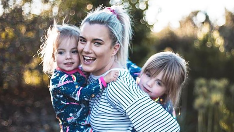 Olivia White hugging her two kids.