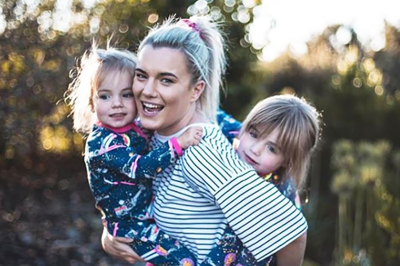 Olivia White hugging her two kids.