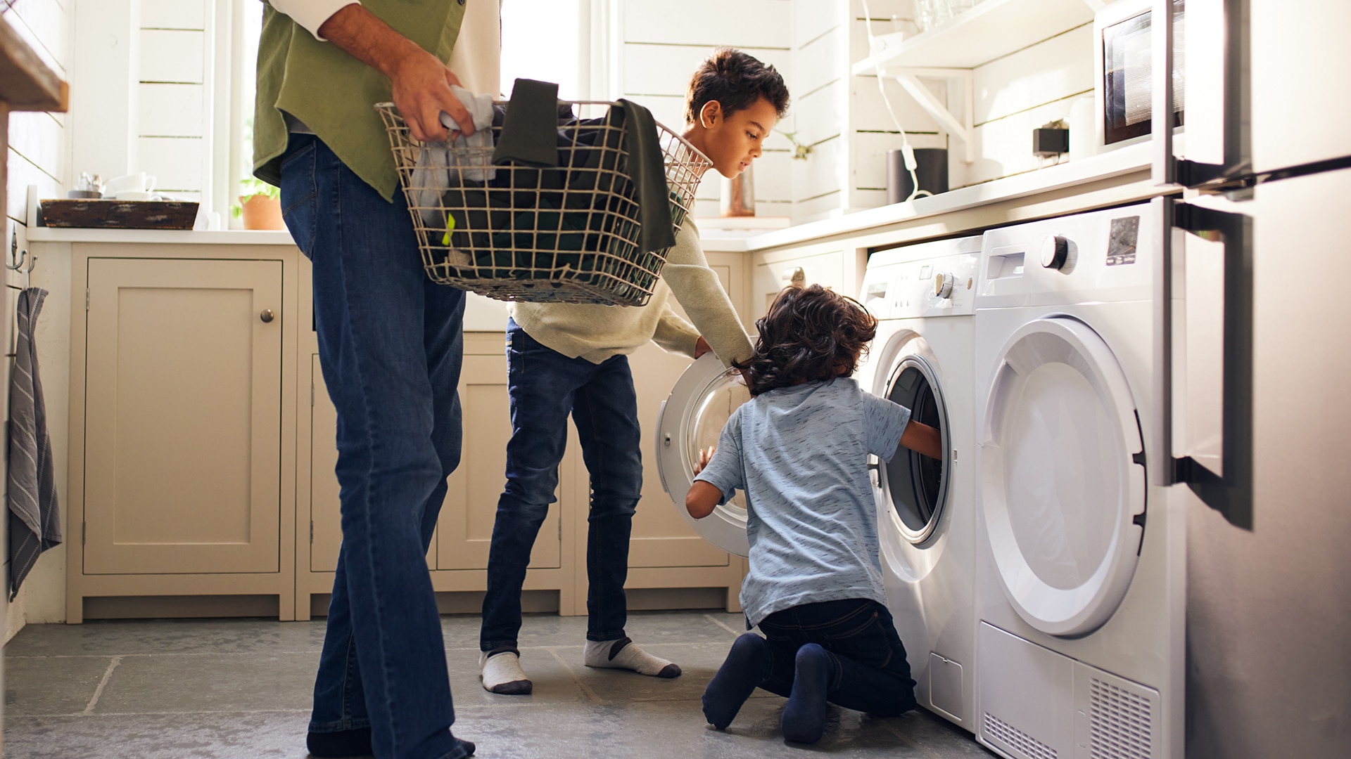 Dad and two sons doing laundry