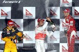 Splashing out: It was Button's first win for McLaren since switching from Brawn GP.