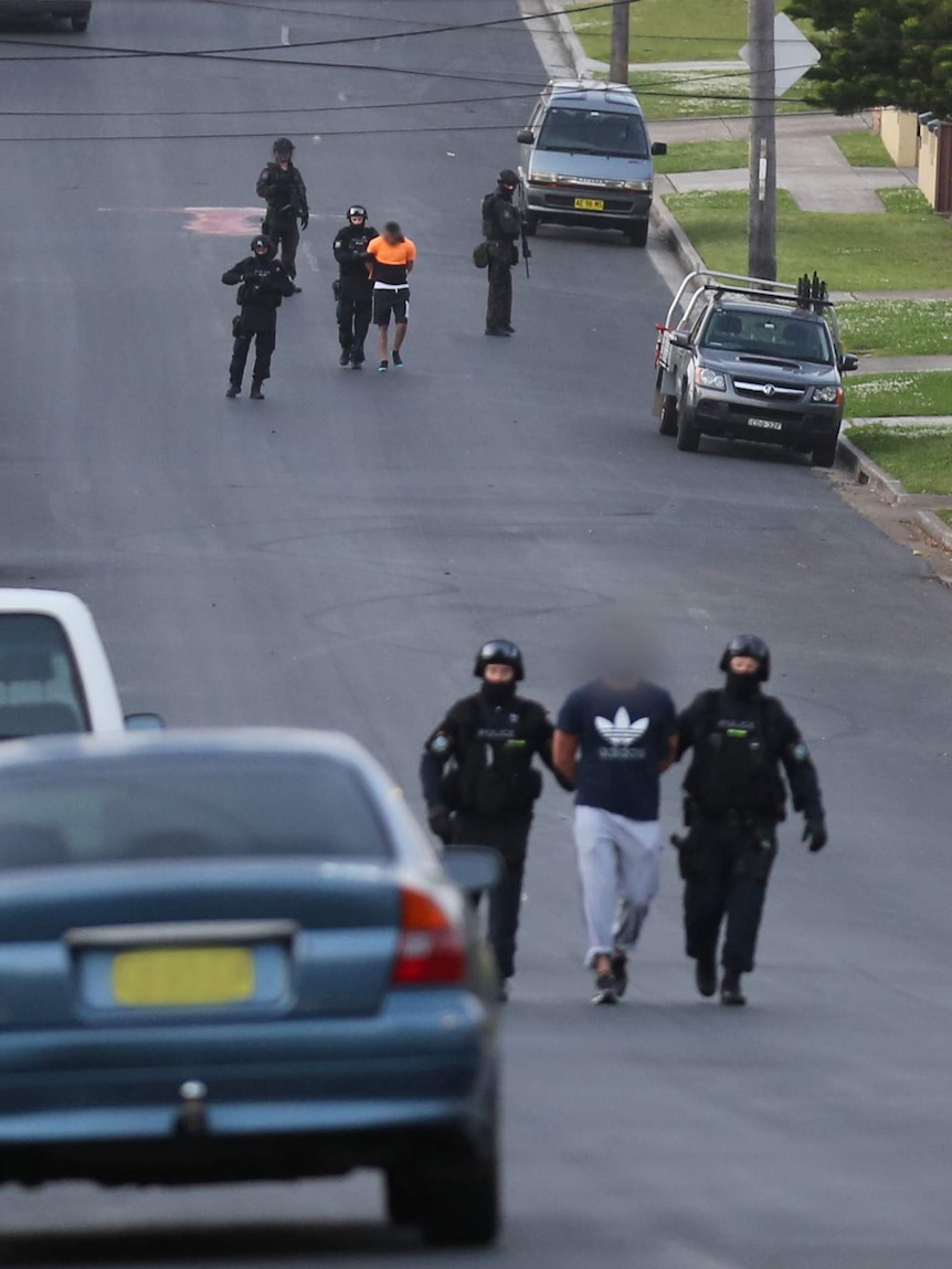 People led away after terror raids