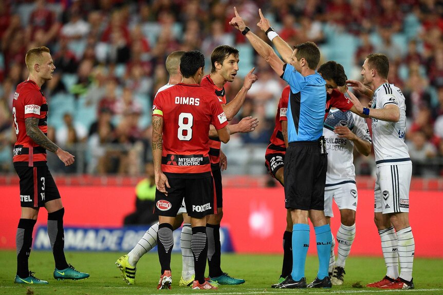 Aritz Borda of the Wanderers remonstrates with referee Chris Beath after Jonathan Aspropotamitis was fouled.