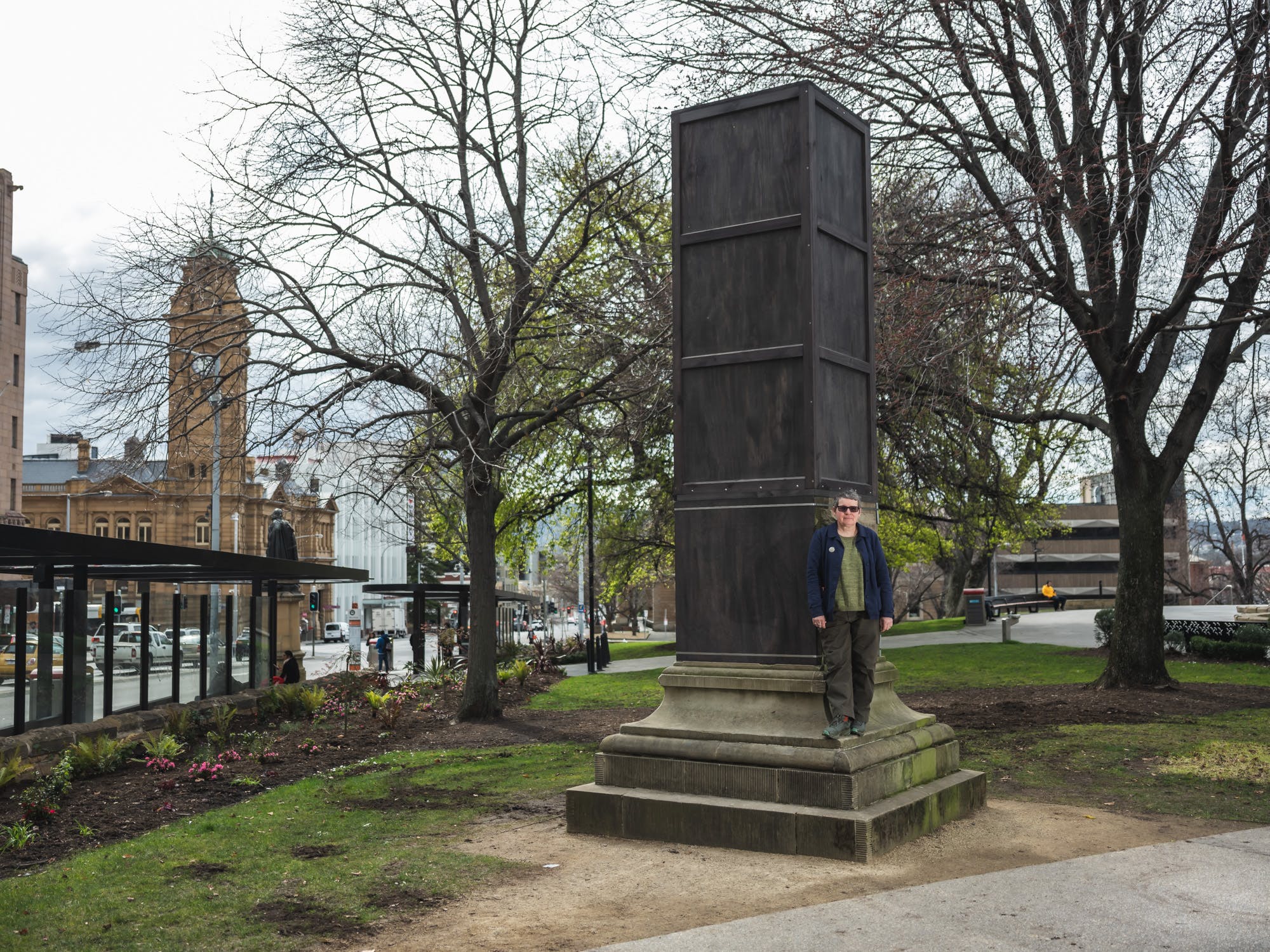 Julie Gough with her art project, a box on a pedestal in a public square.