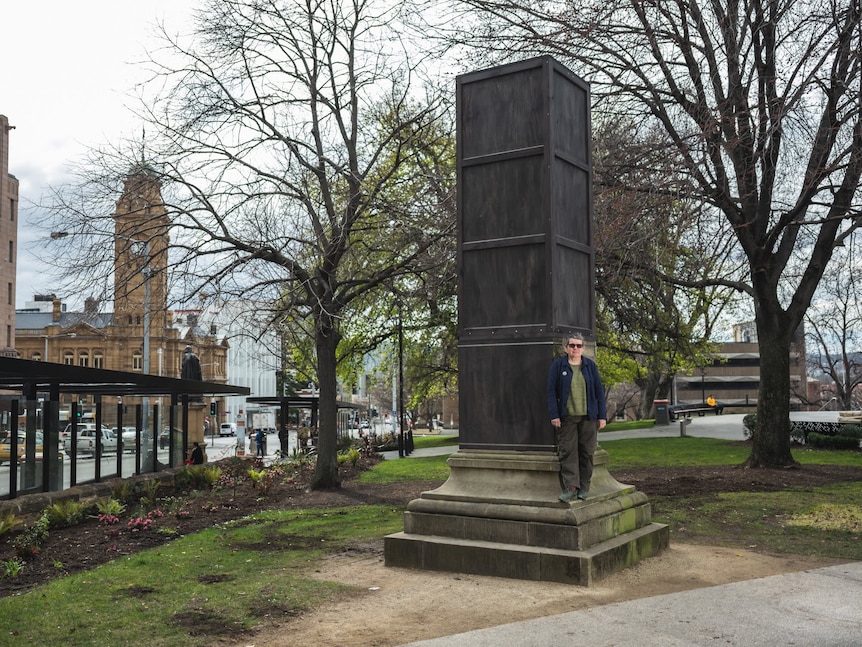 Julie Gough with her art project, a box on a pedestal in a public square.