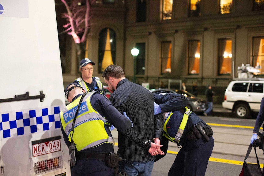 Police arrest a man outside the Sofitel