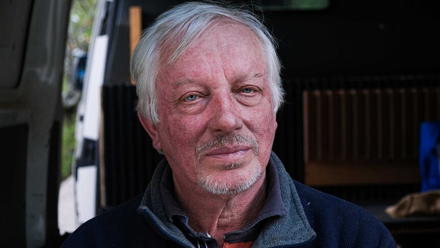 Profile shot of Simon Crosbie, staring into the camera as he sat in the back of his van.