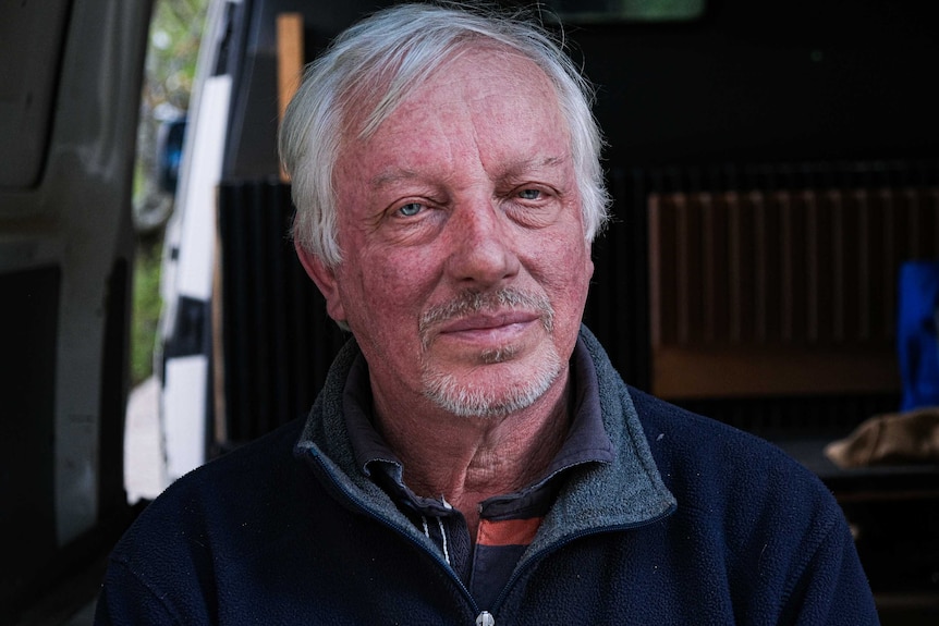 Profile shot of Simon Crosbie, staring into the camera as he sat in the back of his van.