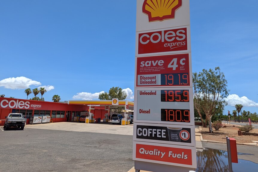 A fuel station sign shows petrol 191.9 and diesel 180.9 in red writing