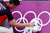 Beach volleyball court gets wipe down ahead of the London Olympics.