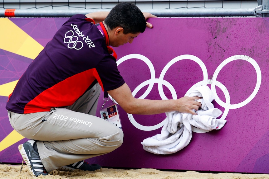 Beach volleyball court gets wipe down ahead of the London Olympics.