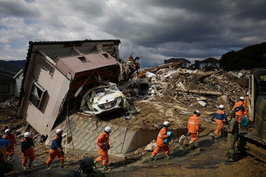 Rescuers conduct a search operation for missing people in Kumano town