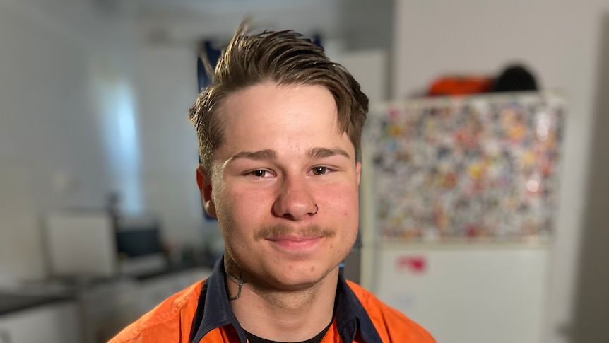 A tradie sitting in a kitchen