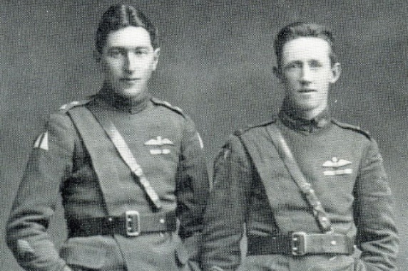 A black and white archive photo of two men in pilot uniforms.