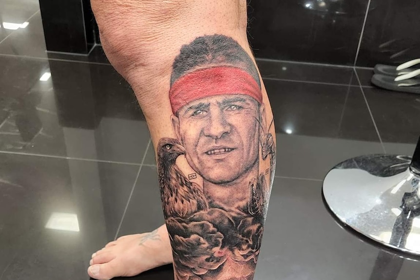 A tattoo of a man on a leg.