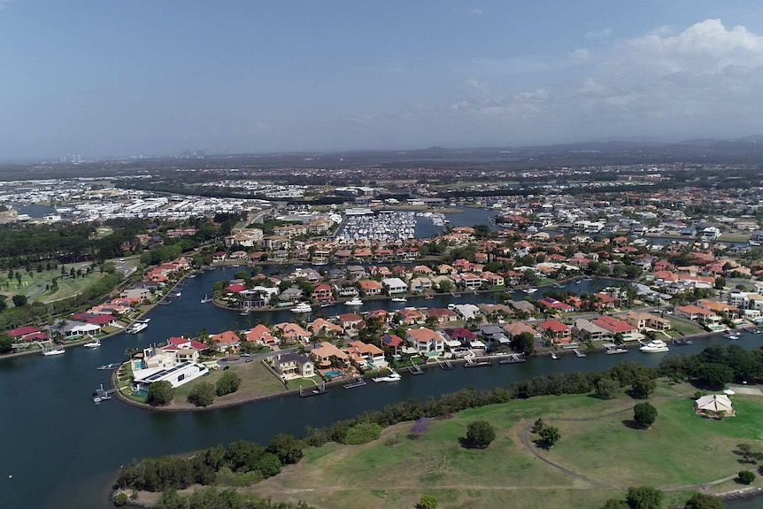 An aerial view of a suburb on a waterway