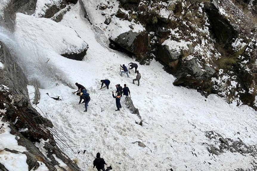 Rescue team members search for survivors after an avalanche in the northeastern state of Sikkim, India.