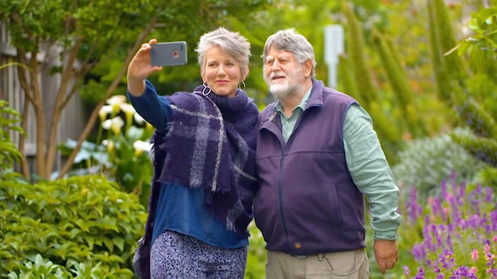 Woman and man taking a selfie in the garden