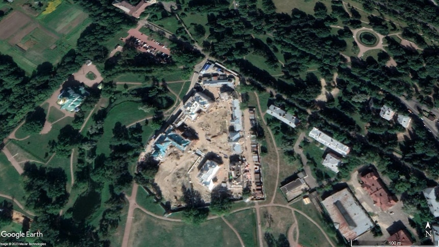 An aerial view shows a large construction site encompassing several buildings