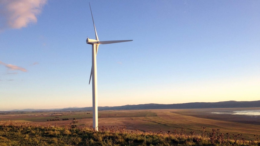 A wind turbine on a hill.