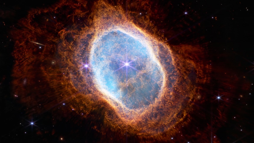 A planetary nebula in shades of blue, orange and red