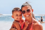 Hannah Clarke, hugs her son Trey Baxter, while standing on a beach.