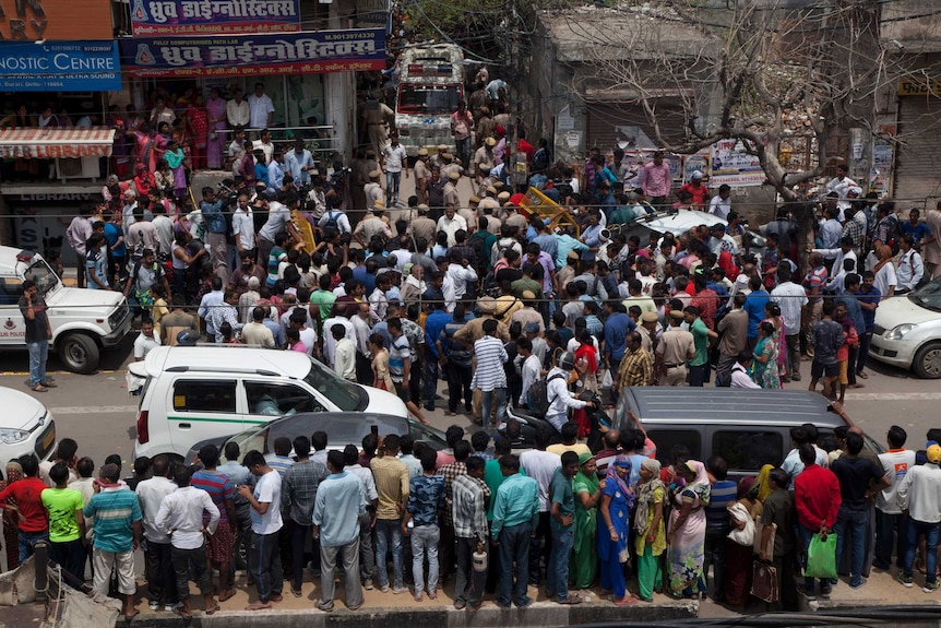 Crowds form outside house where 11 bodies found in India