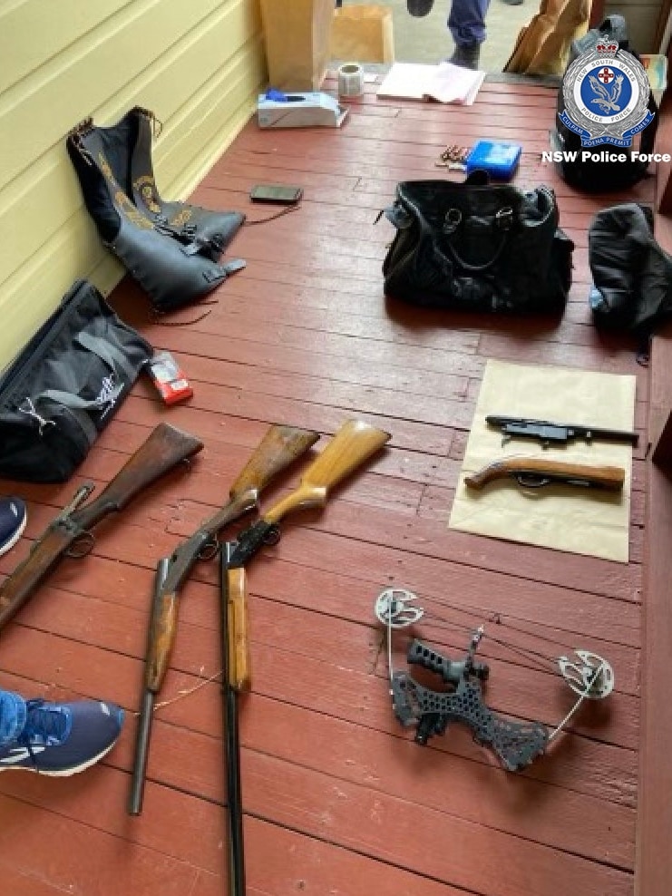 Guns, a bikie vest, a drone are on a verandah