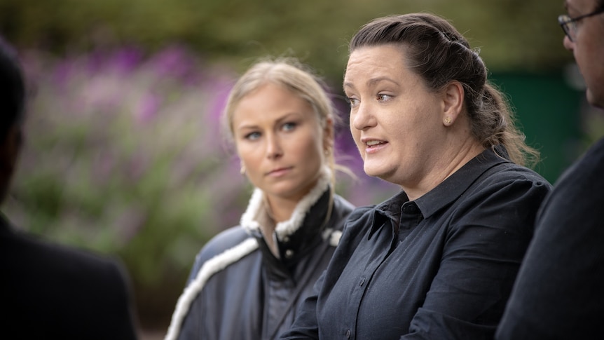 Two women at a press conference.