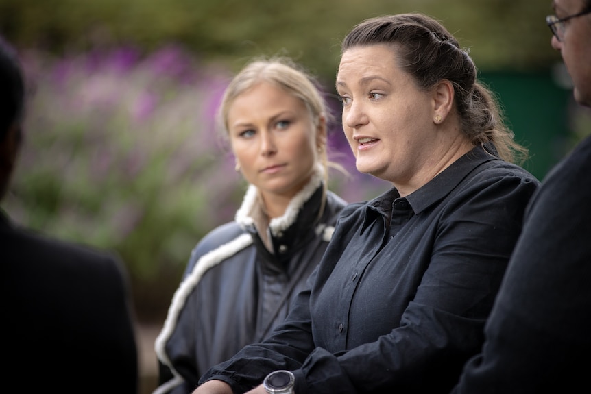 Two women at a press conference.