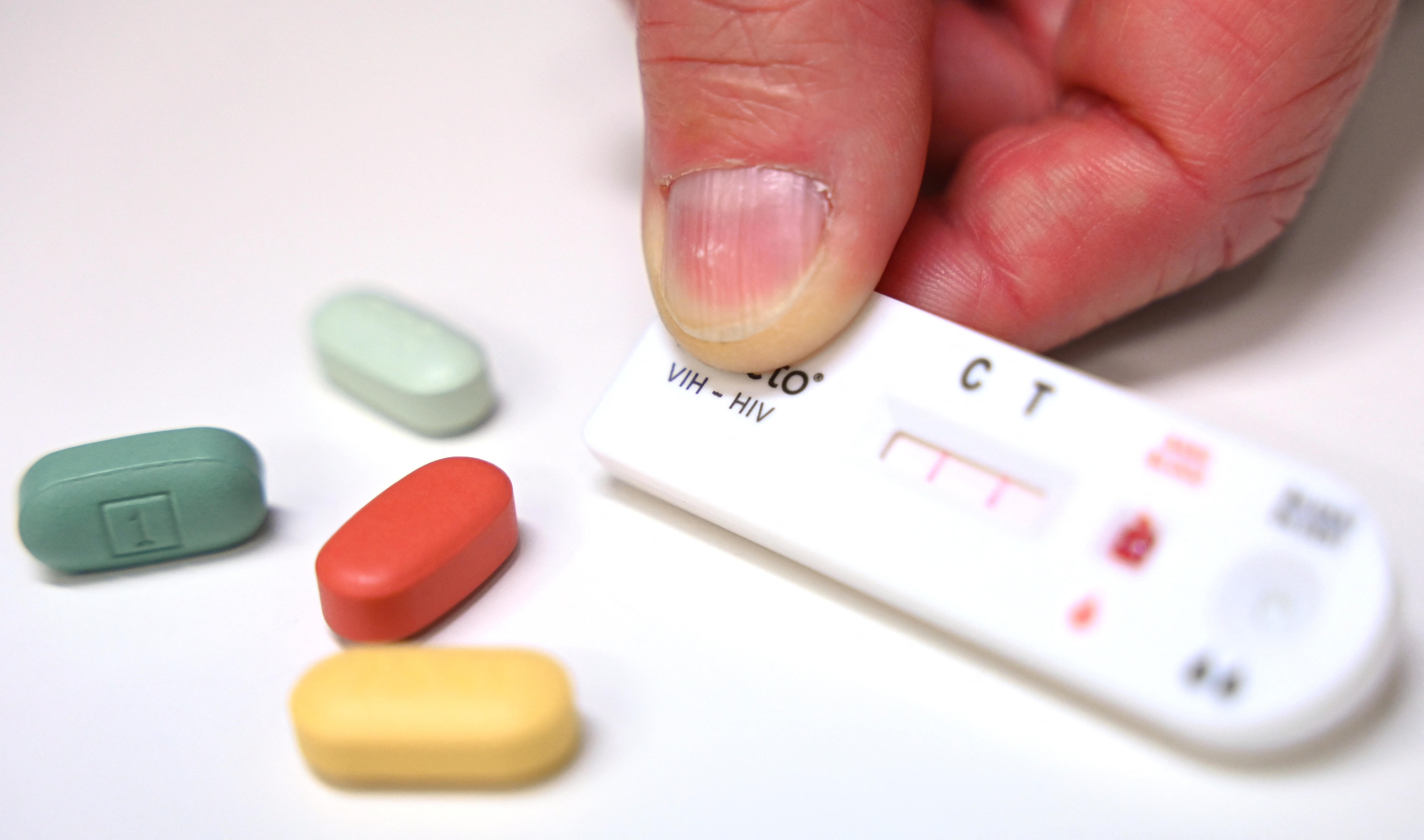 A testing cartridge for HIV and some pills.