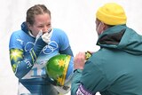 Australia's Jaclyn Narracott (L) reacts with a team member.