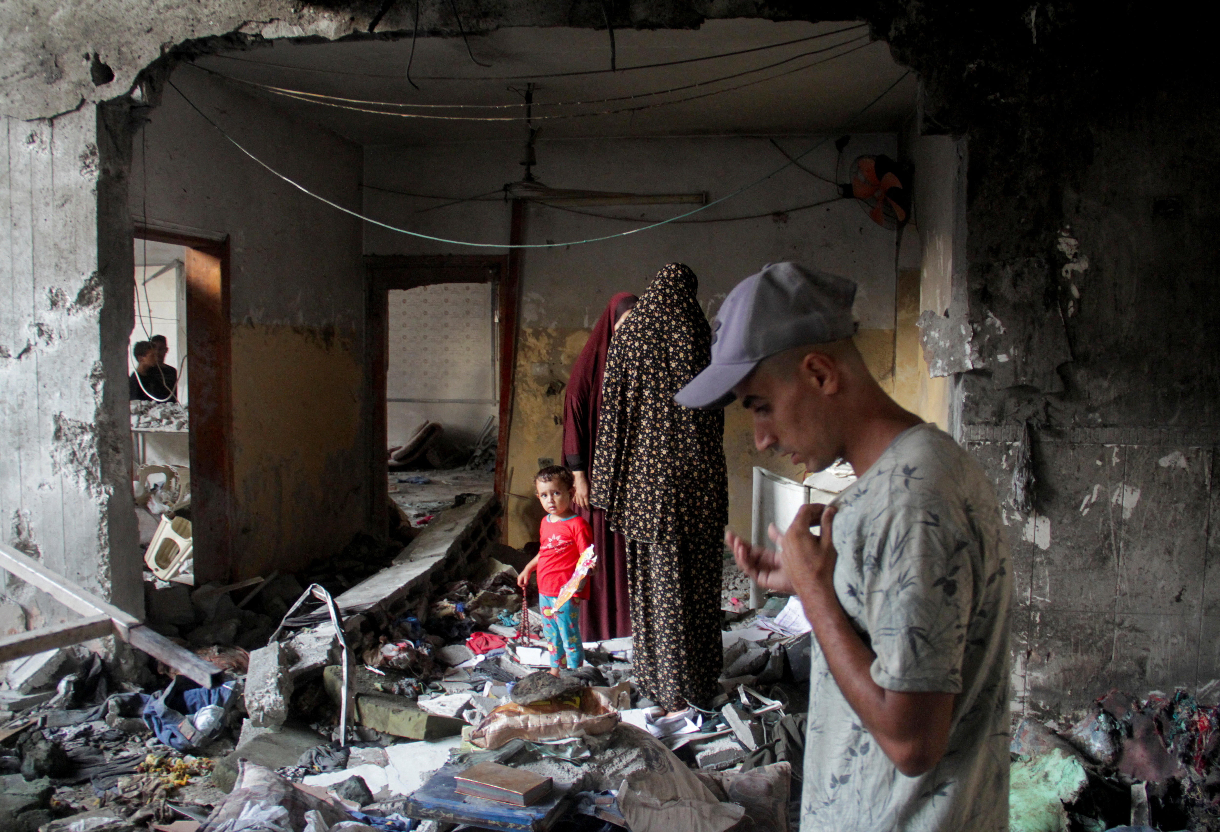 A man looks down at debris in the aftermath of an airstrike 