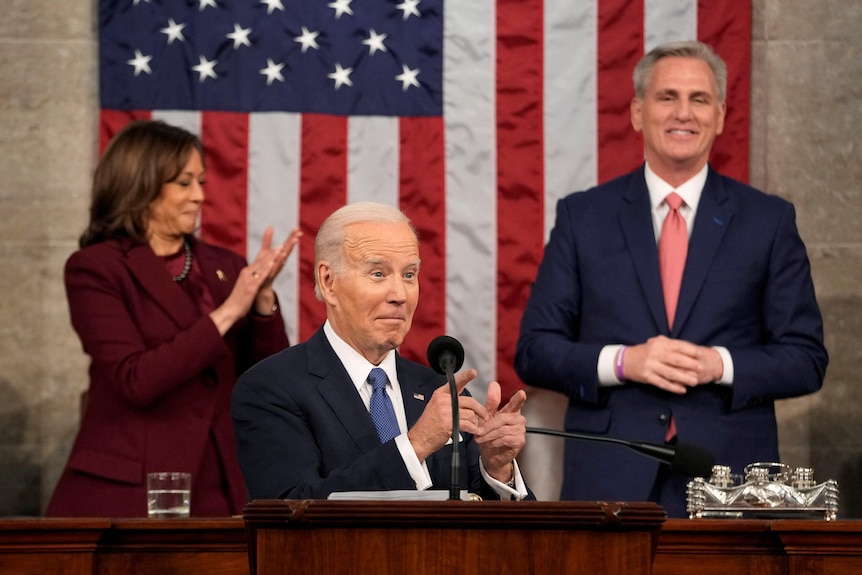 Joe Biden giving finger guns as Kevin McCarthy and Kamala Harris applaud