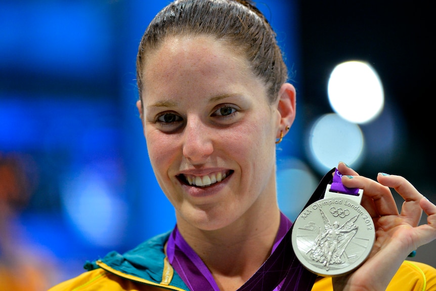 Alicia Coutts holds her silver medal during the women's 200m individual medley victory ceremony.