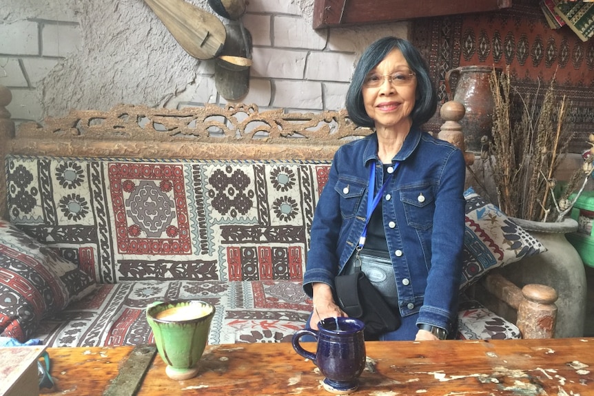 A woman sitting by a table in a cafe in China's western province Xinjiang.