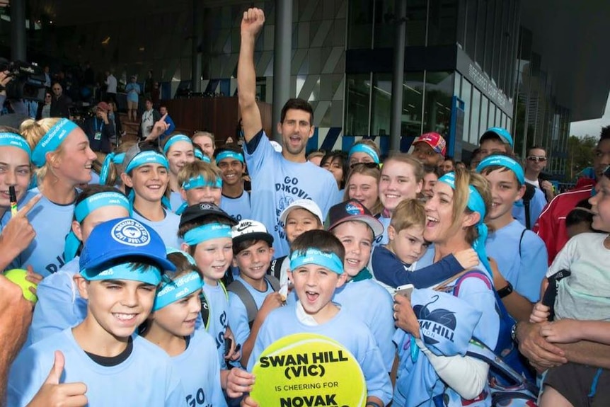 Novak Djokovic poses with children from the Swan Hill Lawn Tennis and Croquet Club.