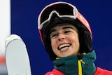 An Australian smiles after winning gold in the women's moguls at the Winter Olympics in Beijing.