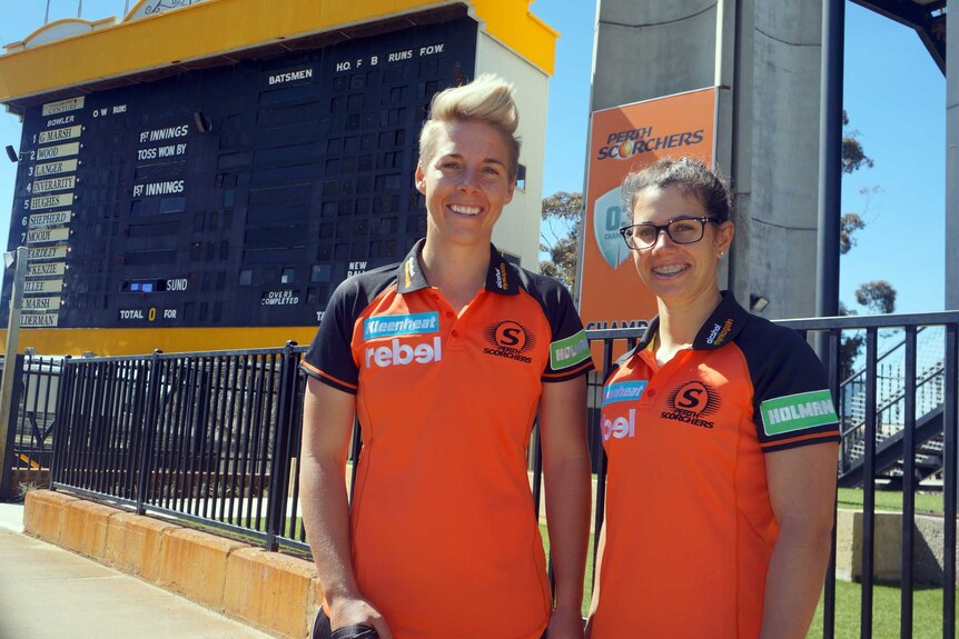 Elyse Villani and Nicole Bolton standing in front of the WACA scoreboard.