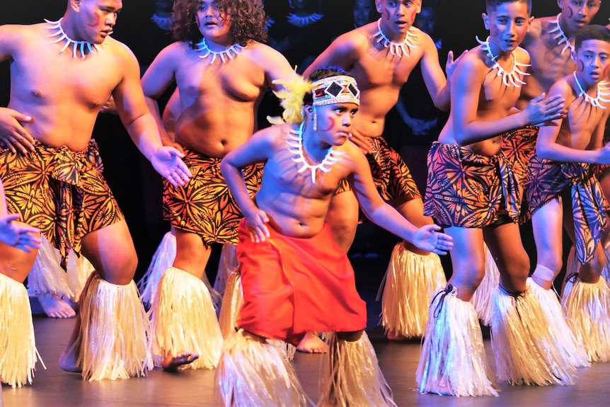 Young men in colourful samoan clothing dancing
