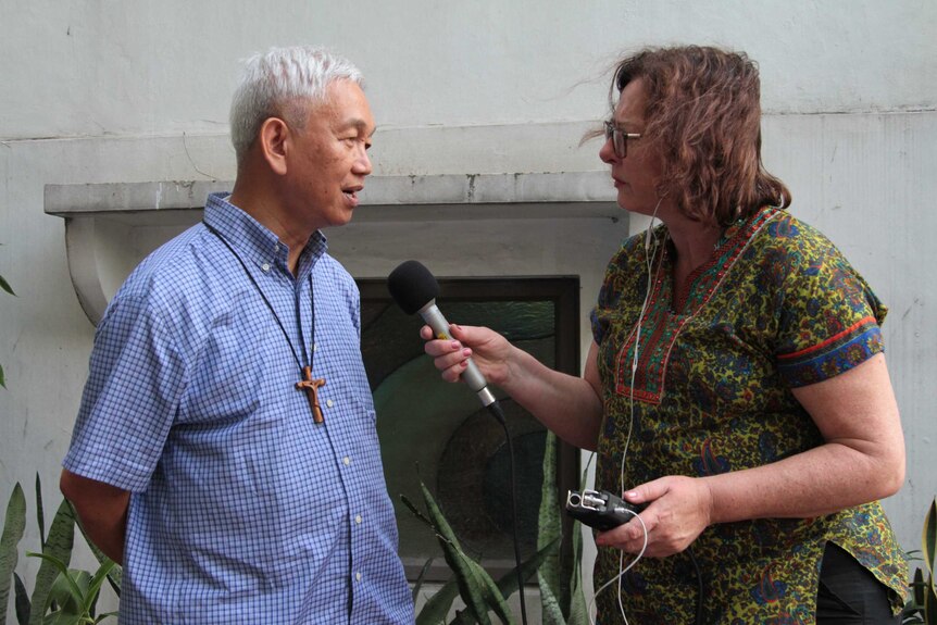 Journalist Ginny Stein interviewing Bishop Broderick Pabillo in The Philippines.