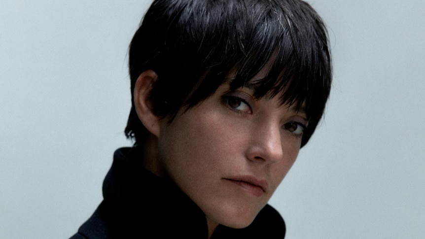 A profile photo of Sharon Van Etten with close cropped hair and turtleneck coat