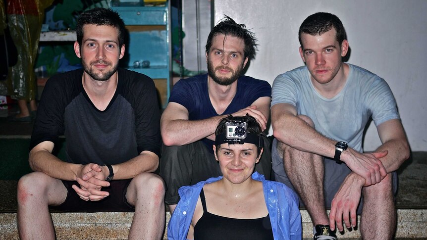 Playwrights Jordan Prosser, David Finnigan, Georgie McAuley and Sam Burns-Warr sitting on steps.