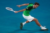 Daniil Medvedev hits a running slice backhand at the Australian Open.