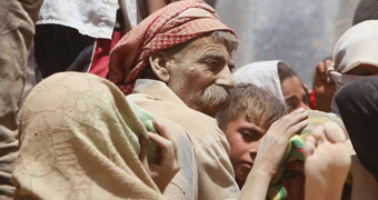 Yazidi man covered in dust