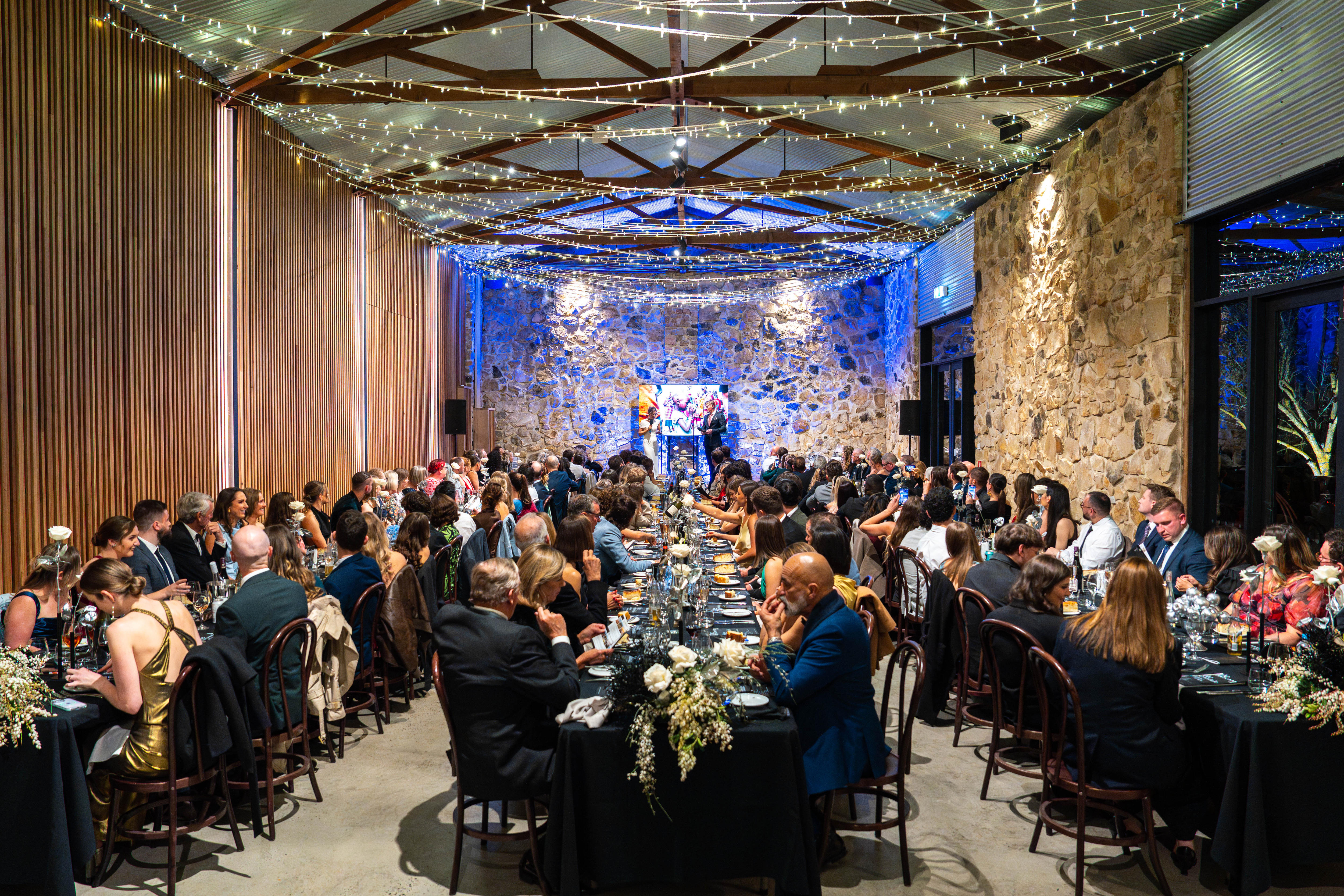 A group of people sitting in a room at a black tie event for OpBlue. 